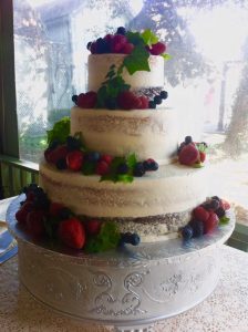 three tier cake with berries throughout