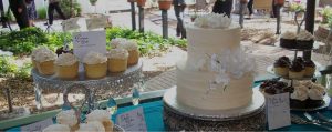 wedding desserts table with cupcakes and cake