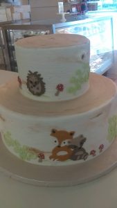 two tiered cake with forest creatures