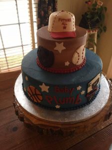 Sport related cake with baseball hat as a topper