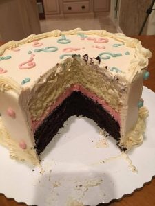 Gender reveal cake cut open with pink layer inside