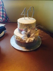 delicate anniversary cake with beads and flowers