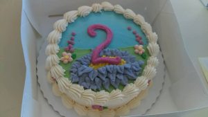 round cake with pink number two on it