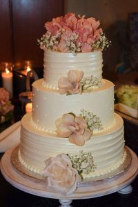tiered wedding cake with blush rose flowers