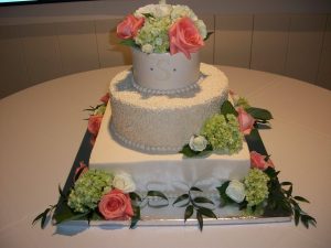 three tier square and round wedding cake with roses