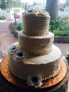 delicate wedding cake with white poppy flowers