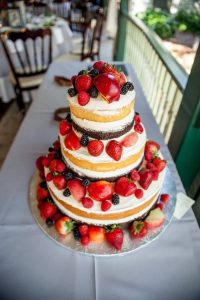 Vanilla and chocolate three tier cake with fresh berries