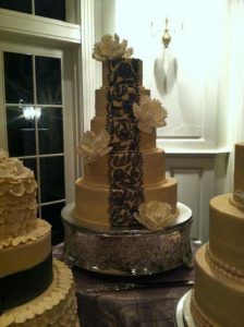 tall wedding cake with chocolate lace details