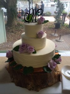 elegant three tier wedding cake with chocolate monogram topper