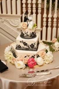square asymmetrical three tier wedding cake with lattice and flower decor