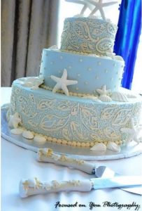 light blue wedding cake with sea stars and seashells